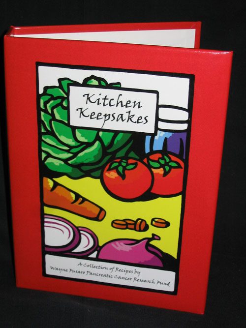A red book with a picture of vegetables on it.
